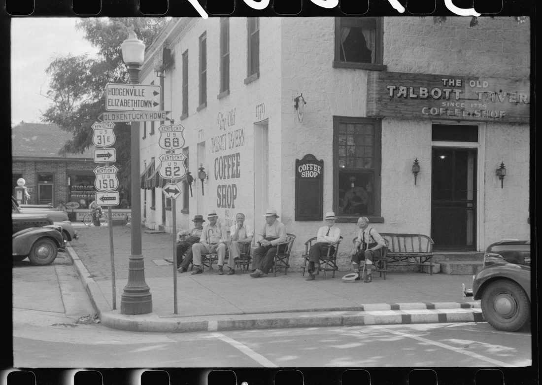 Townspeople visiting while sitting in front of Old Talbott Tavern on Saturday afternoon. Bardstown, Kentucky