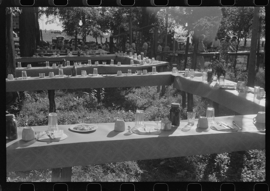 Table in picnic grove set for St. Thomas church supper near Bardstown, Kentucky