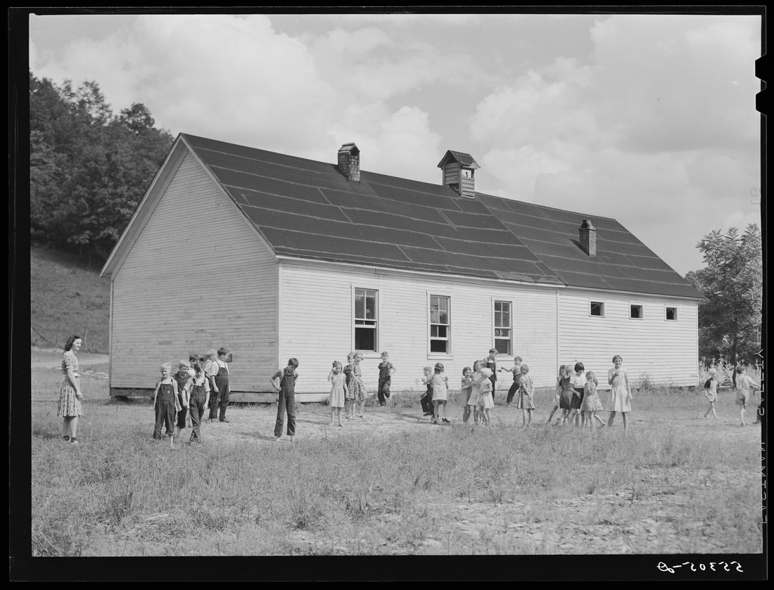 Two-room school house near Morehead, Kentucky. In these mountain areas the school term begins in June and goes through January, because in the late winter and spring months the wea