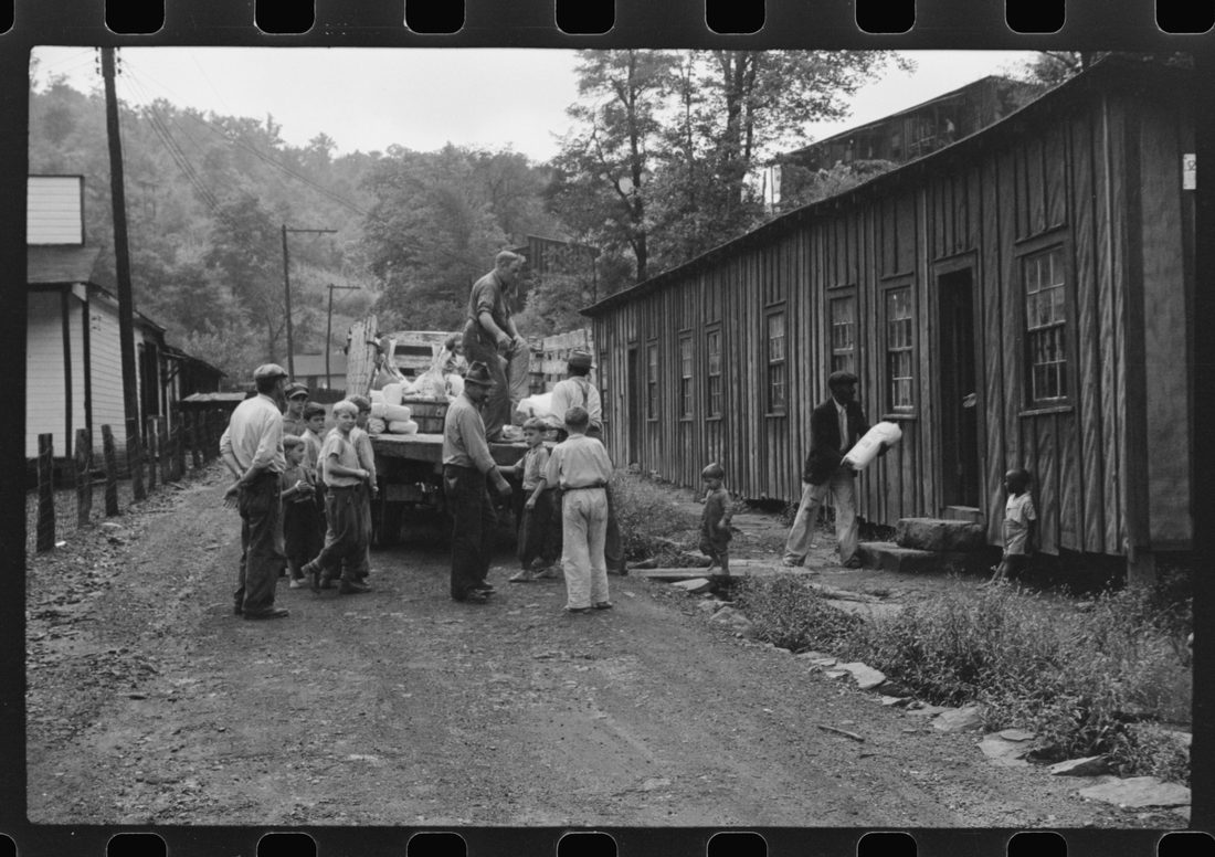 The relief truck brings food supplies to abandoned mining town, Jere, West Virginia. The shack on right is used as community house for prayer and church meetings, union and water c