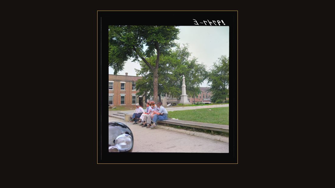 Men idling around the courthouse square. Note Confederate monument characteristic of Southern towns. Roxboro, North Carolina