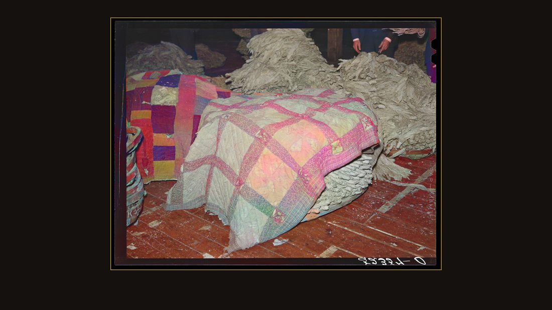 Old quilts and sacks are used to keep tobacco moist and "in order" while waiting for auction sale in warehouse. Durham, North Carolina