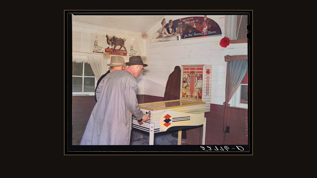 Tobacco buyers playing at pinball machine during lunch hour on day of tobacco auctions. Durham, North Carolina