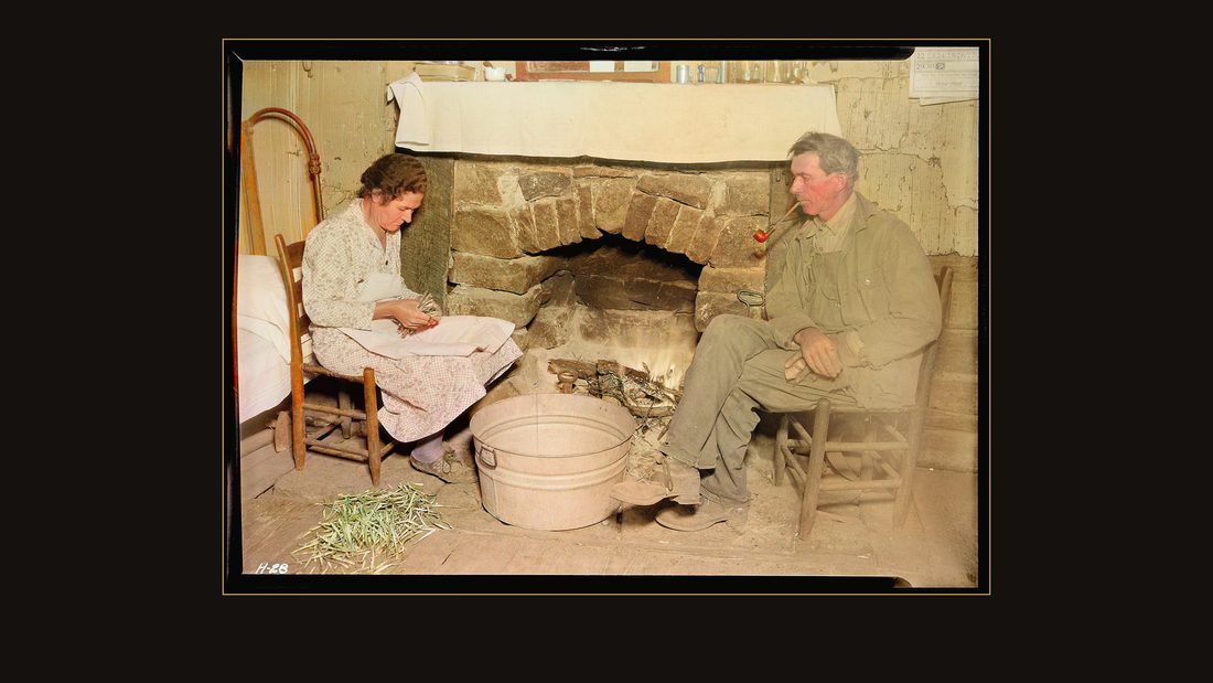 "Mr. J. W. Melton and his wife by the fireplace getting ready for supper. Melton has used up the better part of his life in the mines. His boys run the farm. The Melton homest