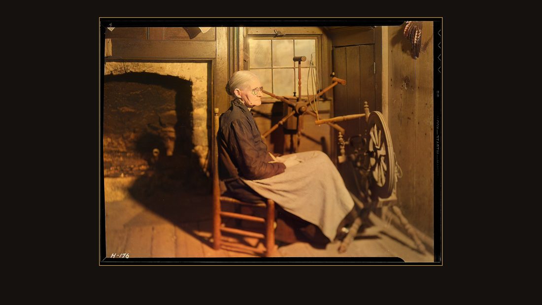 "Another view of Mrs. Jacob Stooksbury, Loyston, Tennessee, seated before a spinning wheel in her home. The creel in the background is used for measuring yarn by the hank.&quo