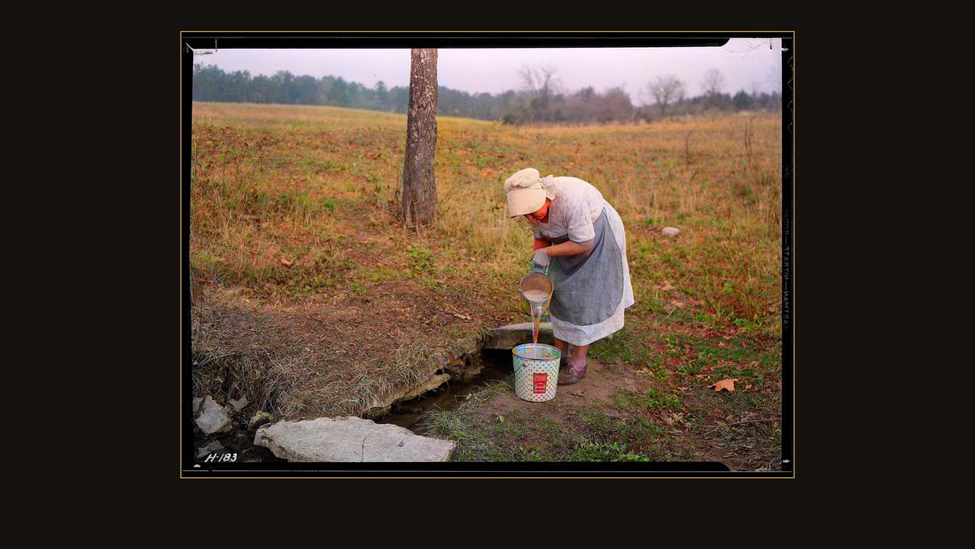 "Mrs. Wallace dipping water from spring on farm near Norris townsite recently purchased by the TVA for experimental purposes. This spring has been in use for 30 years."