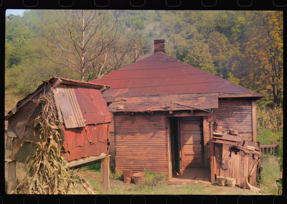 Rear of coal miner's home and homemade corn crib at left. There's not any water or electricity. Bertha Hill, West Virginia
