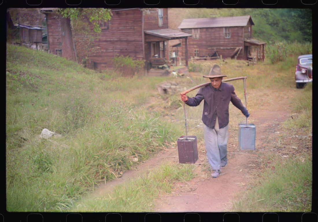 Mexican miner carrying water up the hill to his home, about two miles. Bertha Hill, West Virginia