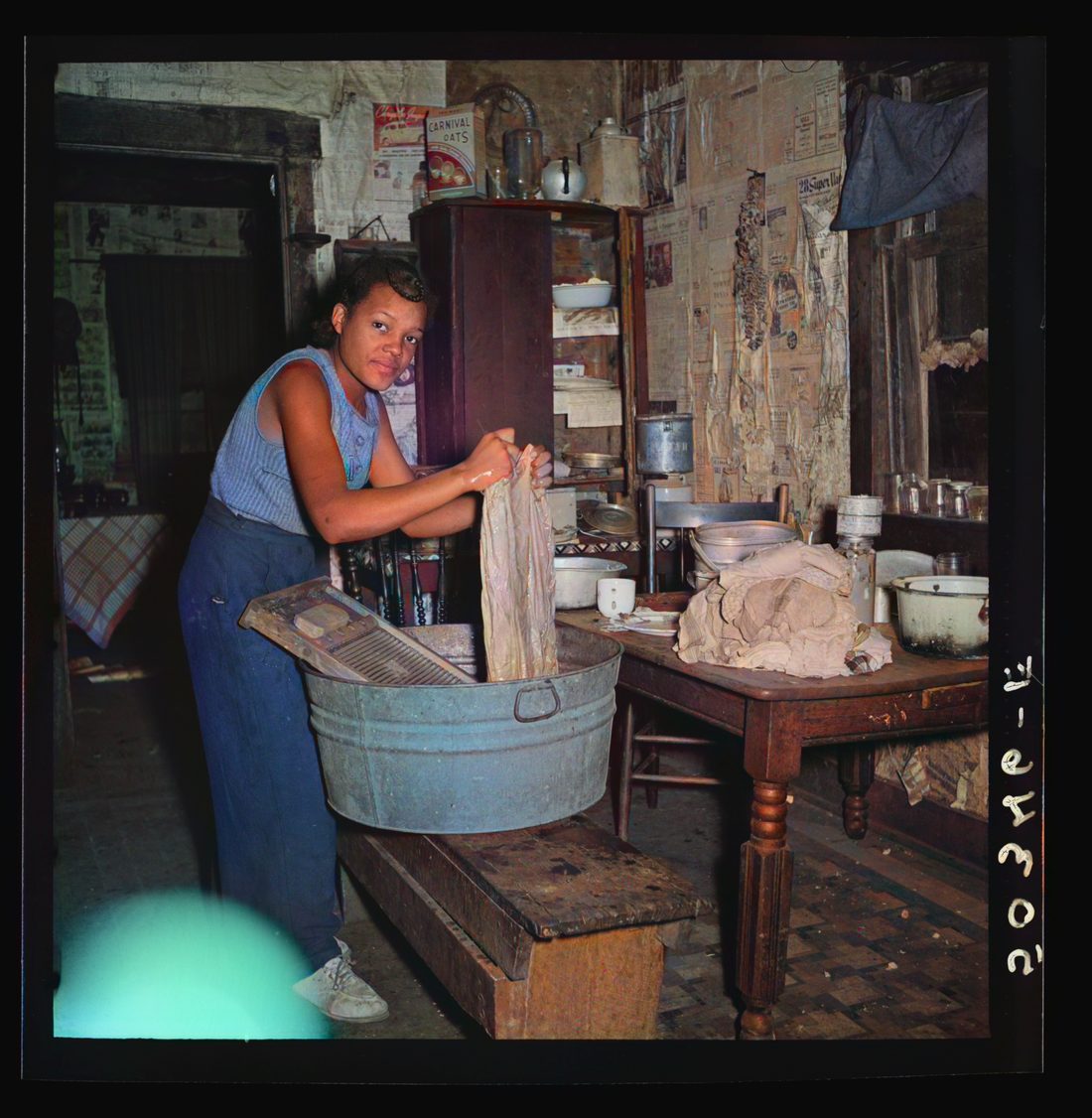 Coal miner's daughter doing the family wash. All the water must be carried from up the hill. Bertha Hill, West Virginia