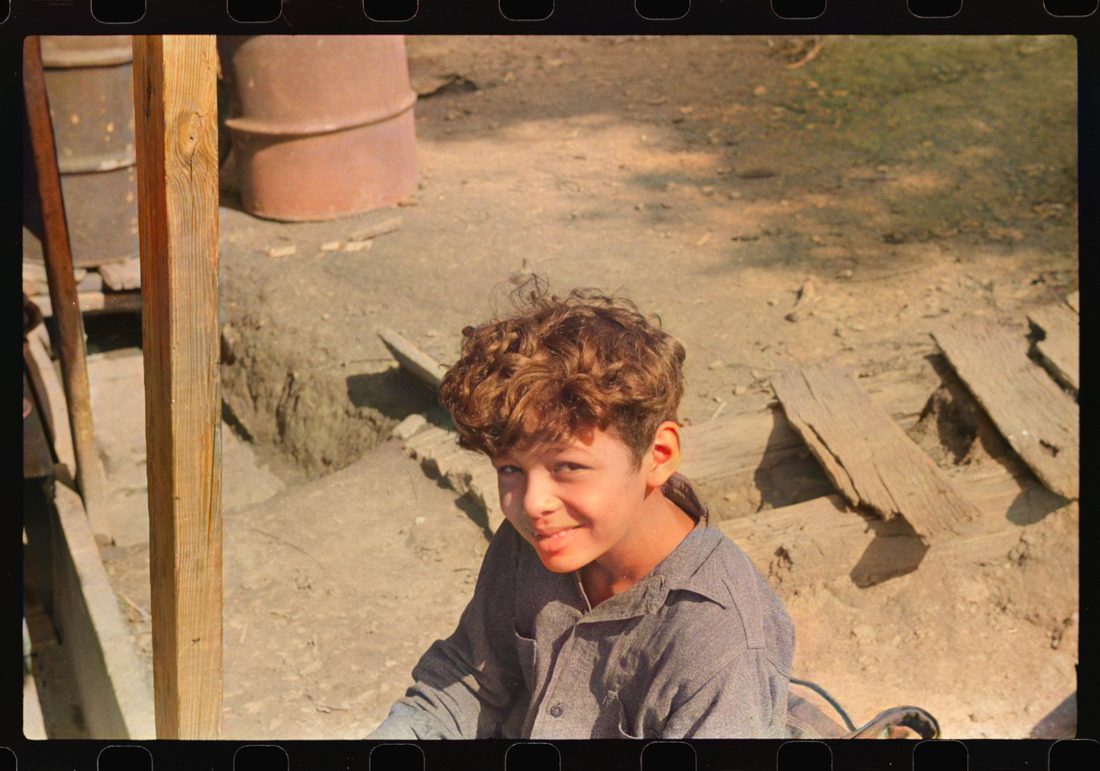 Mexican miner's child, doesn't go to school much. He's too shy and school's too far away, especially when it is cold. Bertha Hill, West Virginia
