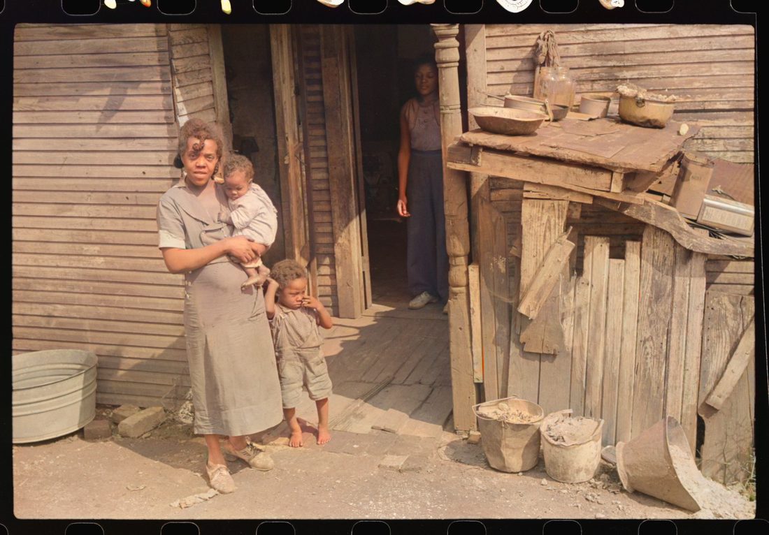 Coal miner's wife and children (note child's legs) in back of their home. Bertha Hill, West Virginia