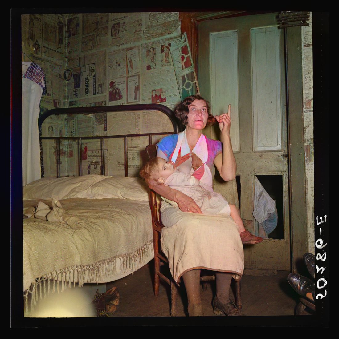 Coal miner's wife and child while discussing conditions of house, lack of steady work for husband. Bertha Hill, West Virginia
