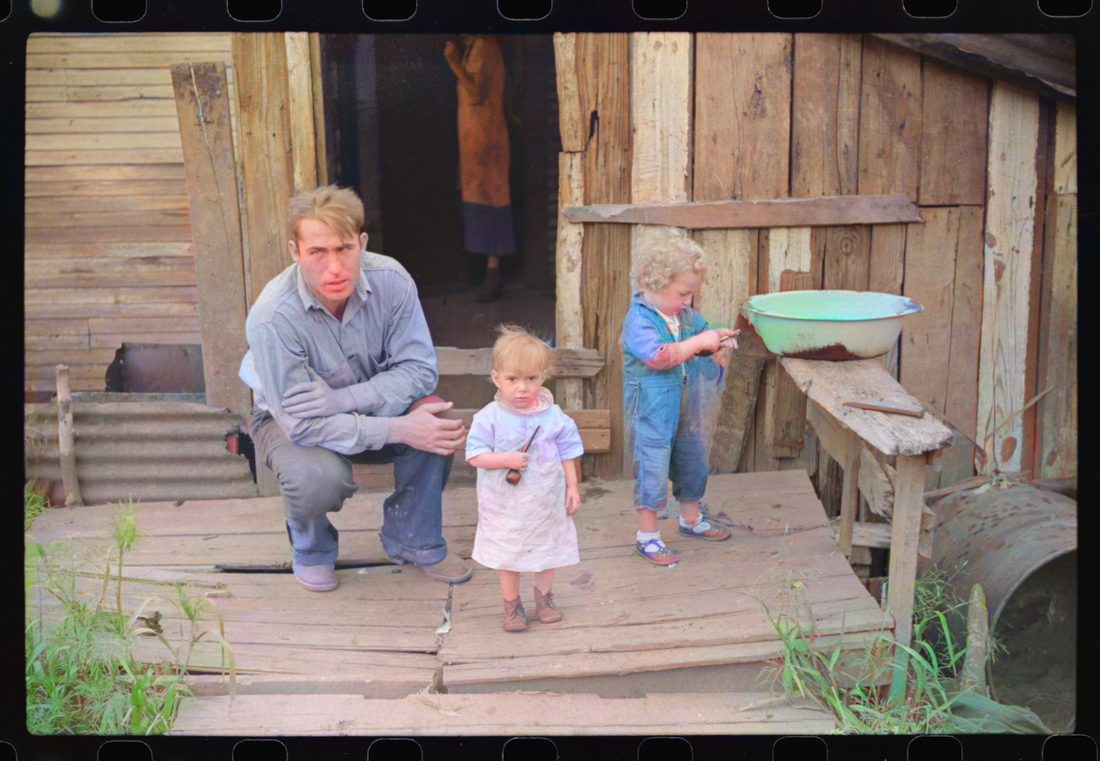 Coal miner and two of his children on their back porch. Bertha Hill, West Virginia