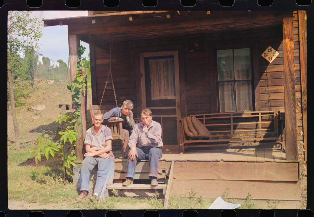 Coal miner and two boys "sittin" around on front porch. Bertha Hill, West Virginia