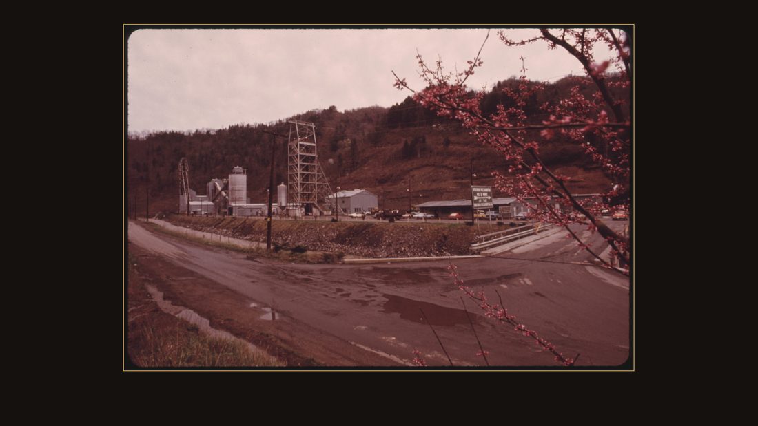 PICTURE OF VIRGINIA-POCAHONTAS MINE #2 NEAR RICHLANDS VIRGINIA, IN A PICTURESQUE SETTING WITH A RED BUD TREE IN THE FOREGROUND. IT IS TYPICAL OF THE CLEAN TYPE OF OPERATIONS AT ALL
