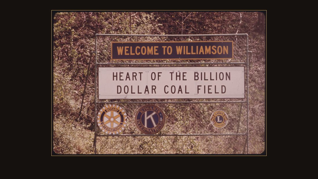 SIGN AT THE ENTRANCE TO WILLIAMSON, WEST VIRGINIA, PROCLAIMS THE TOWN IS IN THE HEART OF COAL FIELDS. ROTARY, KIWANIS AND LIONS SERVICE CLUB (LEFT TO RIGHT) SIGNS NOTE THAT THOSE O