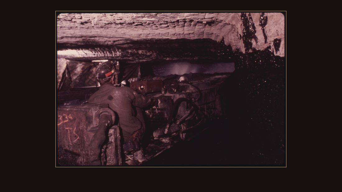 MAN OPERATING A CONTINUOUS MINER IN VIRGINIA-POCAHONTAS COAL COMPANY MINE #3 NEAR RICHLANDS, VIRGINIA. NOTE THE WATER SPRAYING IN FRONT OF THE MACHINE TO KEEP COAL DUST PARTICLES O