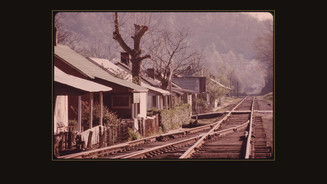 VIEW OF MINERS' HOMES IN A COAL COMPANY TOWN NEAR LOGAN WEST VIRGINIA. NEXT TO THE RAILROAD TRACKS. THEY ARE ACROSS THE ROAD FROM THE MINE SUPERVISORS' HOMES. THE ONE STO