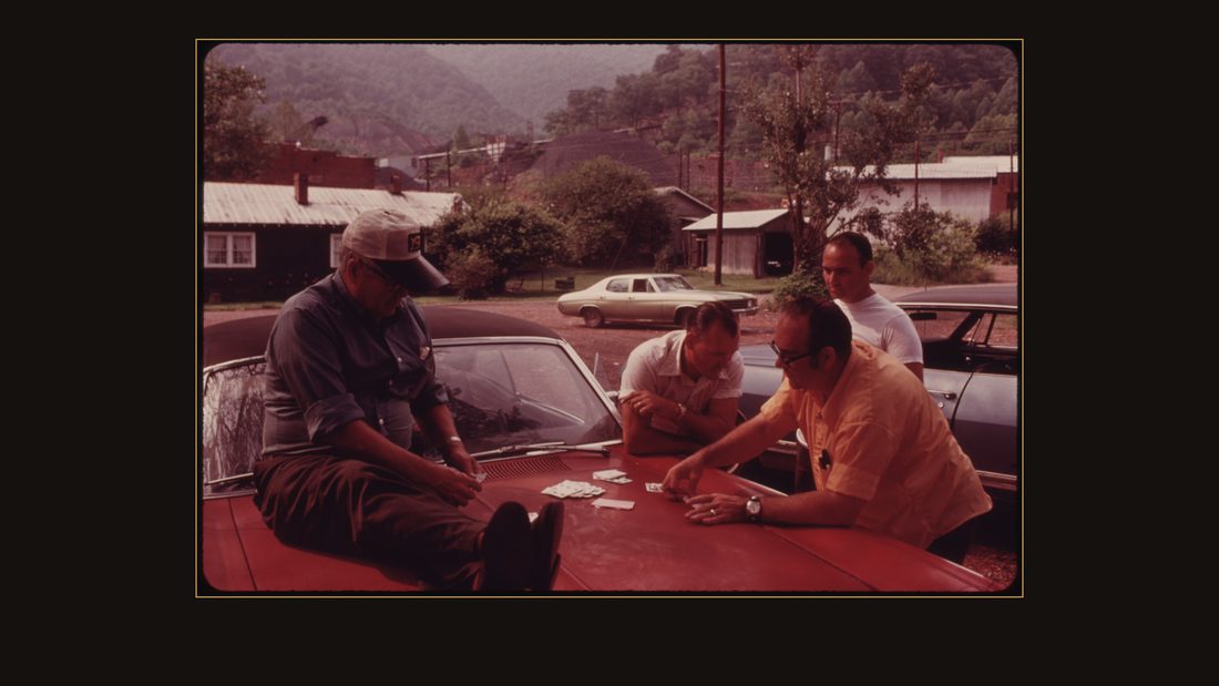 PICKET LINE AT THE BROOKSIDE MINE COMPANY IN HARLAN COUNTY KENTUCKY, NEAR MIDDLESBORO IN THE SOUTHEASTERN PART OF THE STATE THE STRIKERS ARE PLAYING CARDS ON THE HOOD OF A CAR. THE