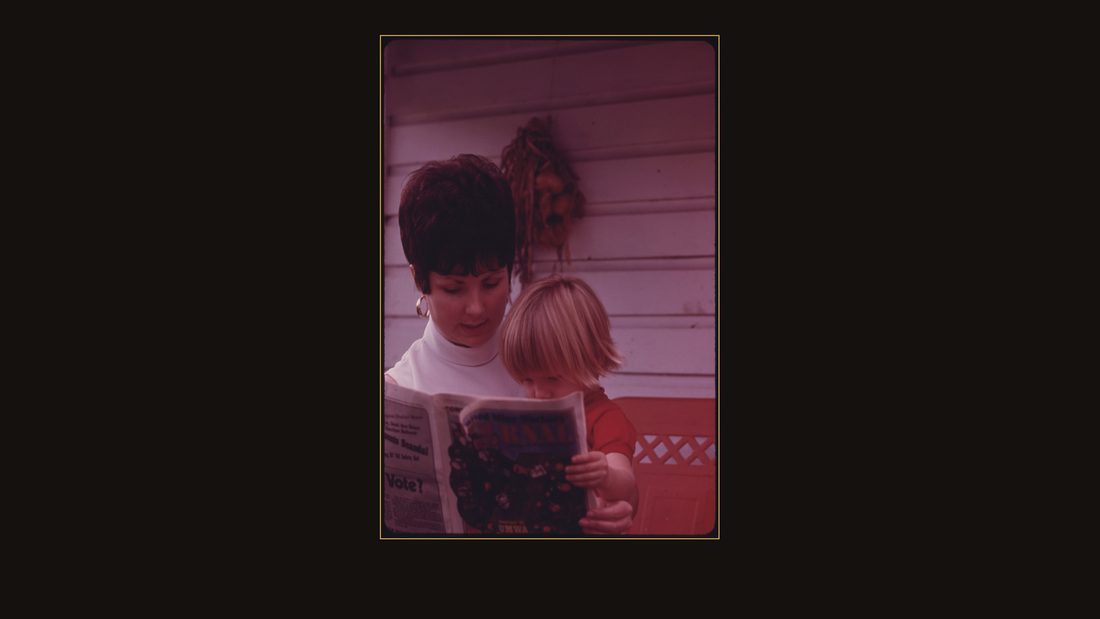 MRS. SHARON BOWLING, 25, AND SON, MARK, 2, OUTSIDE THEIR HOME IN CUMBERLAND, KENTUCKY. WIFE OF A MINER, SHE IS SHOWN LOOKING AT THE UNITED MINE WORKERS JOURNAL, HER "BIBLE&quo